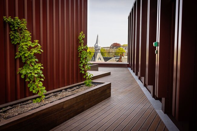 Wooden terrace walkway on the roof of a hotel in Aarhus, enclosed