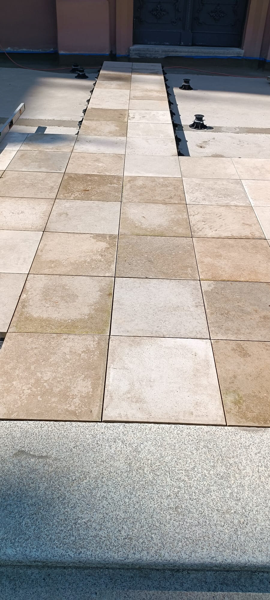 Paver tiles perfectly flush with the historic curb