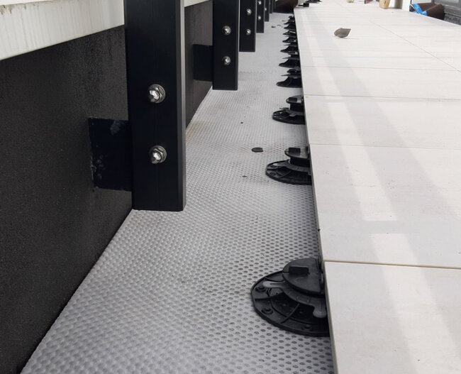 Adjustable pedestals solver under pavers on a raised deck terrace