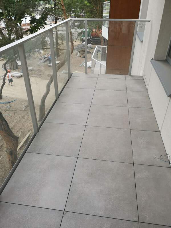 Finished raised deck terrace with 2 cm ceramic porcelain pavers on solver pedestals