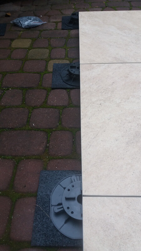 Adjustable pedestals renovation of a terrace from paving stones to a terrace with pavers on pedestals