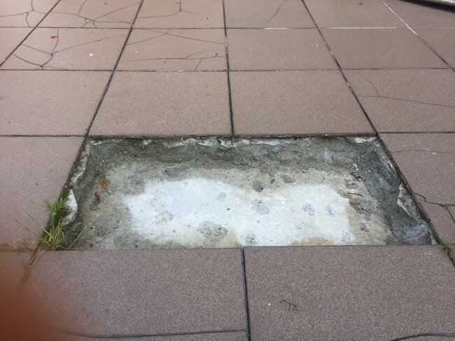 Fallen tiles from a glued terrace