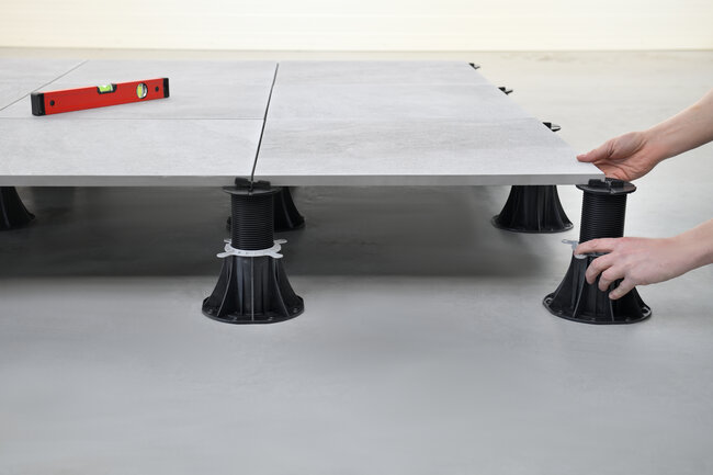 Installation of ceramic pavers on adjustable pedestals