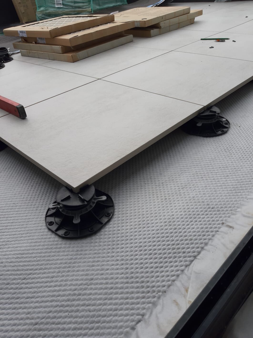 Terrace pedestals with ceramic pavers installation
