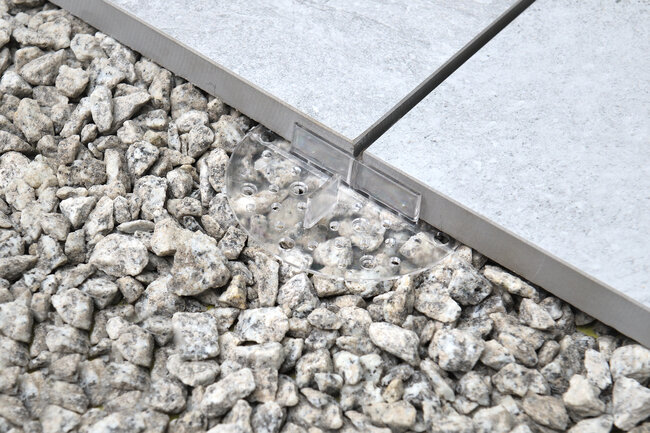 Transparent pad solver 2 mm under ceramic gres tiles laid on gravel