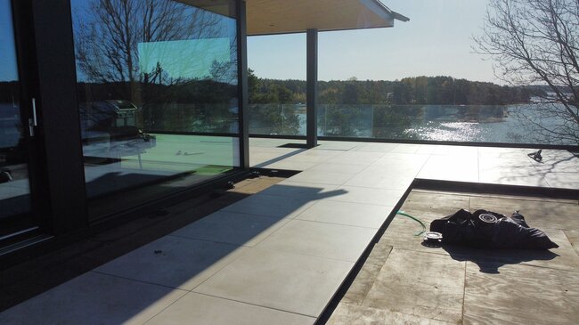 Teras with pavers in a modern house by the water in Finland 2