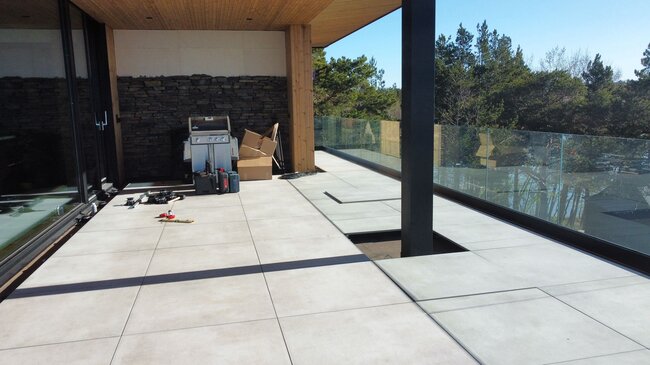Terraces with pavers in a modern house by the water in Finland 3