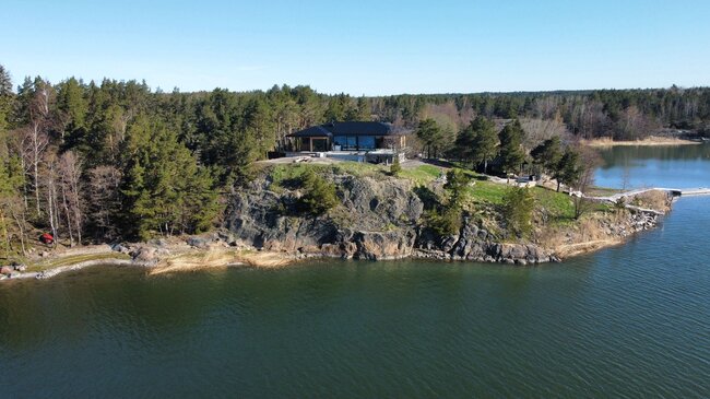 Teras with pavers in a modern house by the water in Finland 4