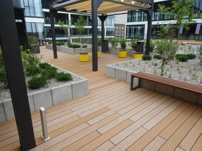 Public space on a raised deck terrace on the roof on pedestals with a composite board