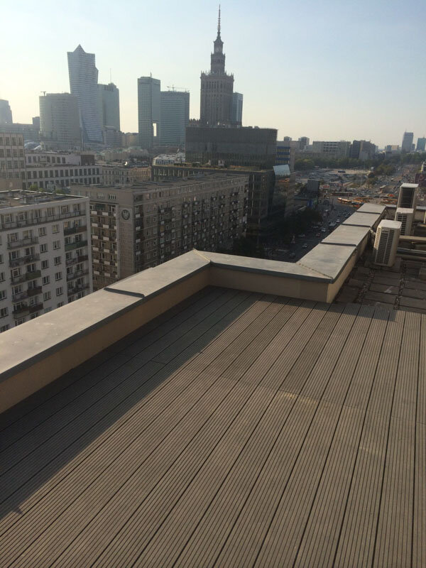 Terrace pedestals on a flat roof with a view of the city panorama