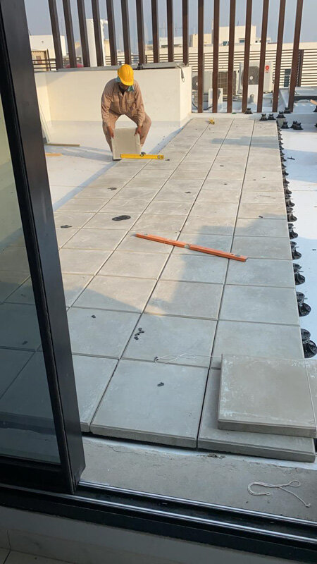 Laying light concrete pavers on standard adjustable pedestals