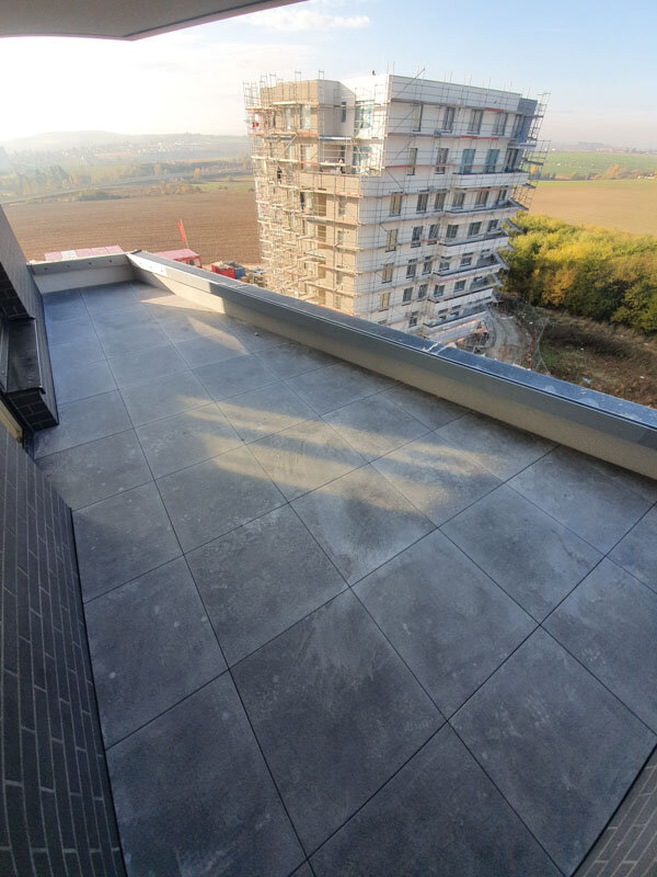 View of a concrete paver terrace on a tall building