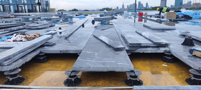 Stone pavers on the roof of the museum terrace on adjustable pedestals solver