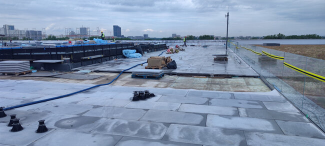 Terrace pedestals standard on a usable flat roof with concrete pavers