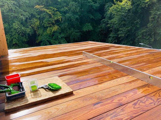 Wet natural wood boards on a raised deck terrace
