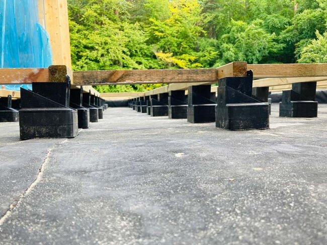 Raptor pedestals supporting wooden joists on a raised deck terrace