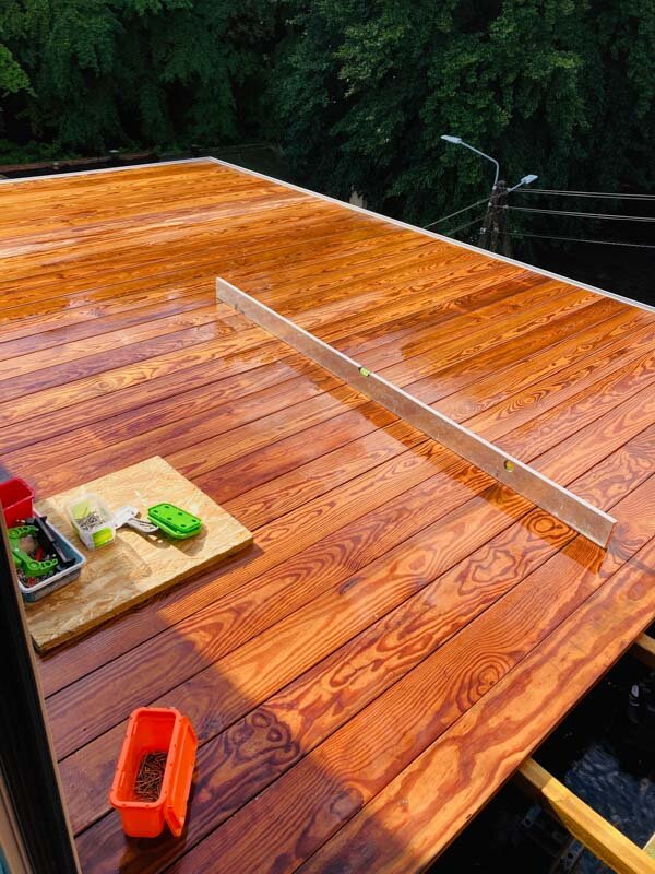 Even wooden terrace made of natural boards with joists and solver pedestals