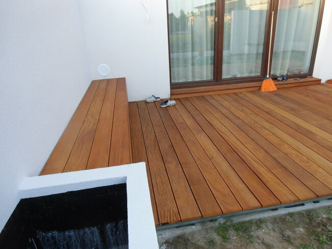 Wooden terrace with a bench made of natural wood