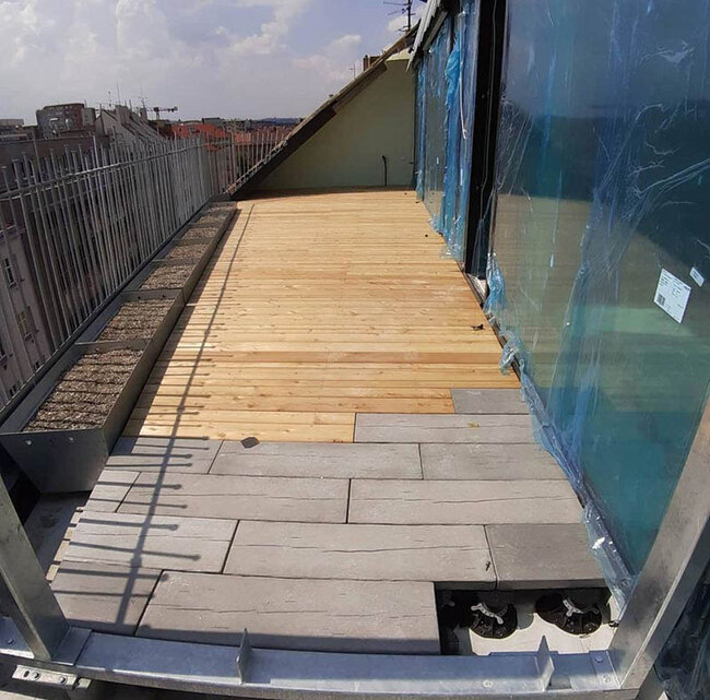 Terrace with concrete pavers and natural wood boards
