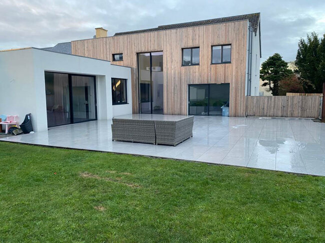 Large terrace next to the building laid on pedestals finished with pavers