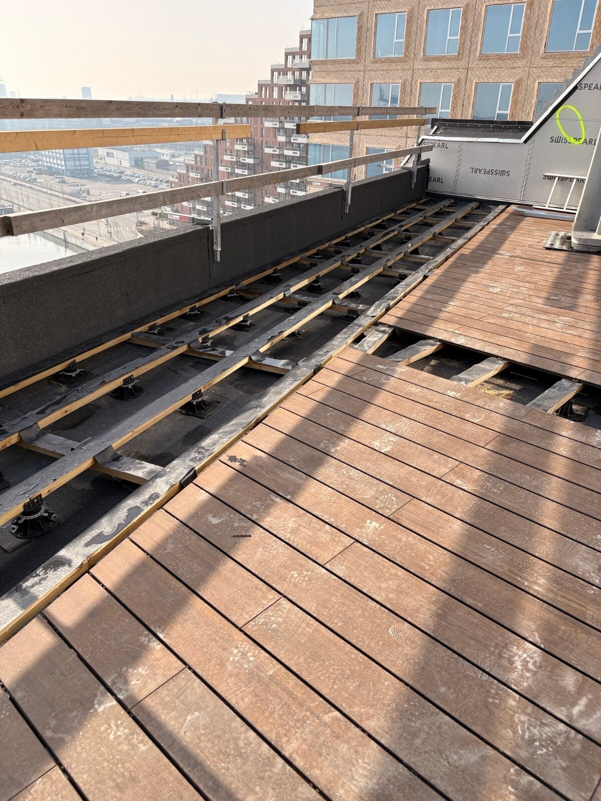 Elevated terrace finished with boards on joists with adjustable solver pedestals