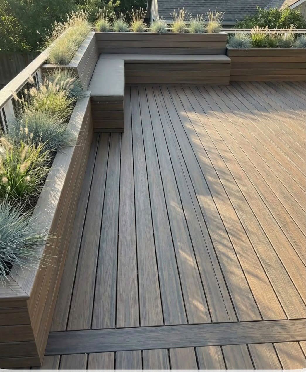 Composite deck terrace with olive trees in pots.