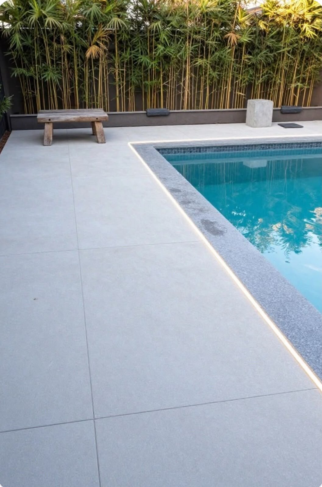Elegant garden terrace with light stone pavers and purple lavender.