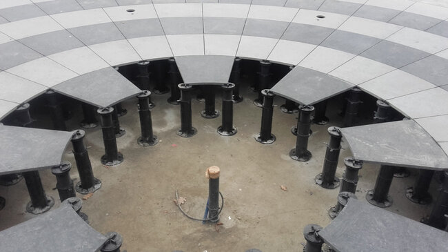 Terrace pavers on adjustable pedestals with SBR rubber pads