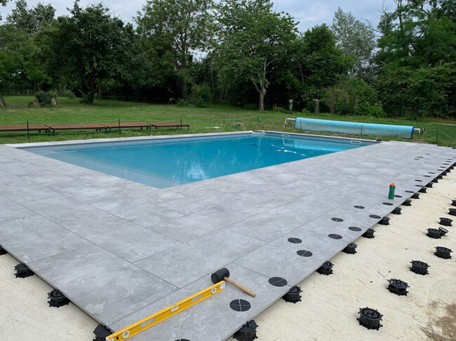Modern floor fountain in a square with dark concrete pavers