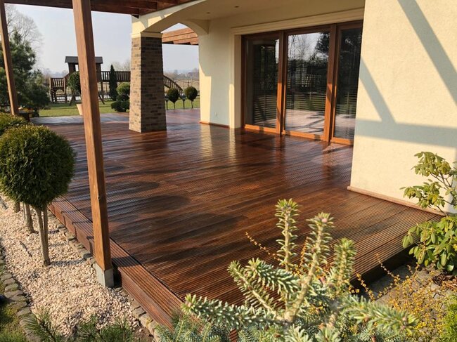 Installation of terrace pavers on adjustable pedestals around a garden pool