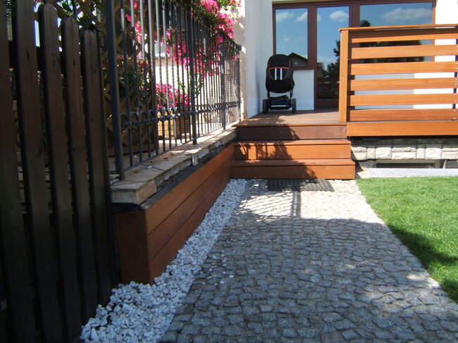 Small wooden terrace with an awning and a wooden garden trellis