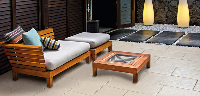 Wood-look terrace pavers on support pads in a garden arrangement with stones