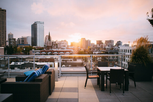 Raised deck terrace with large-format pavers on the roof of a building with a view of the city