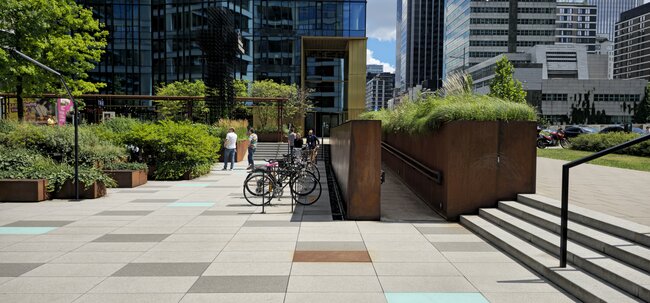 Large-format terrace pavers in a public square in front of a modern office building.
