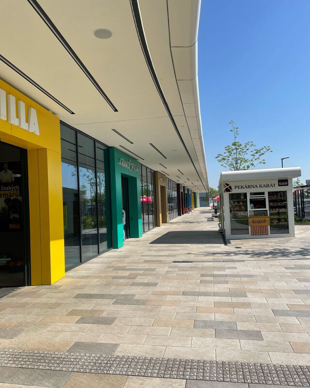 Flooring with terrace pavers in front of a shopping arcade.