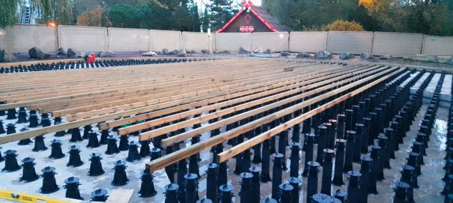Installation of the terrace substructure on adjustable plastic pedestals