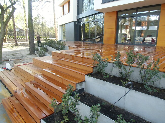 Cascading raised deck terrace with exotic boards and wooden garden stairs.