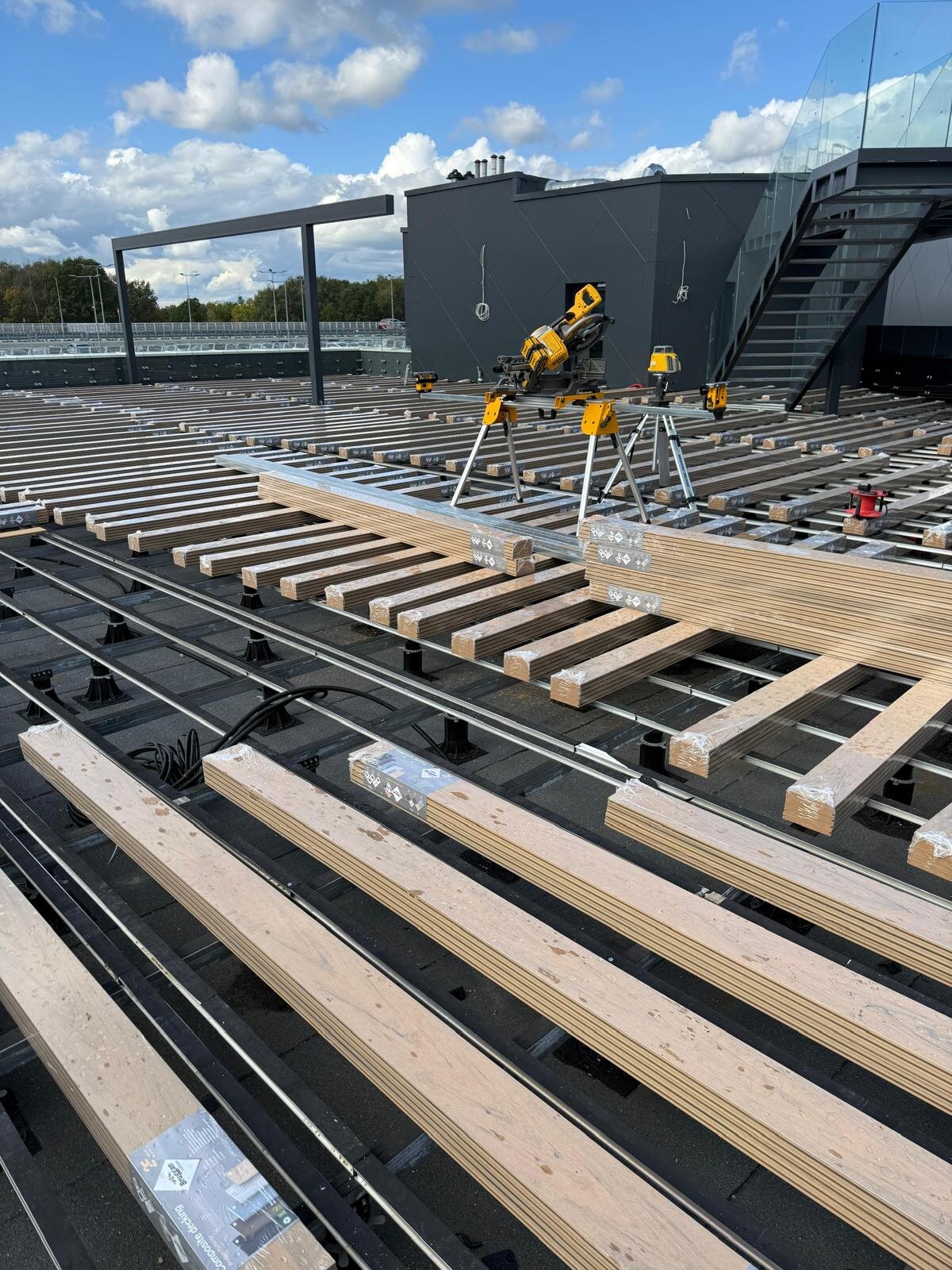 Installation of composite decking boards on a large-format terrace