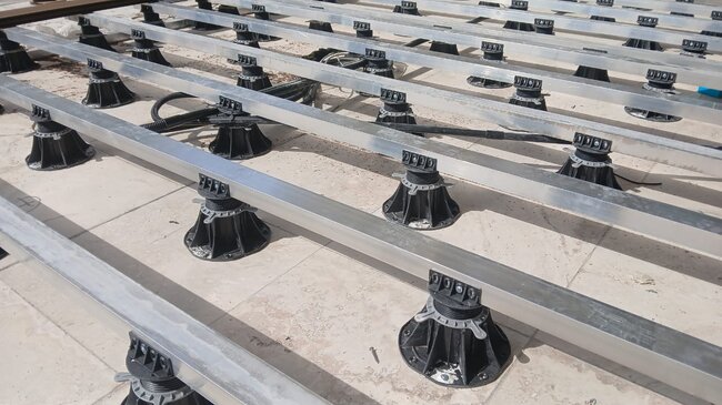 Aluminum joists laid on adjustable pedestals under the terrace
