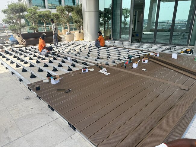 Installation of composite boards on joists and adjustable pedestals