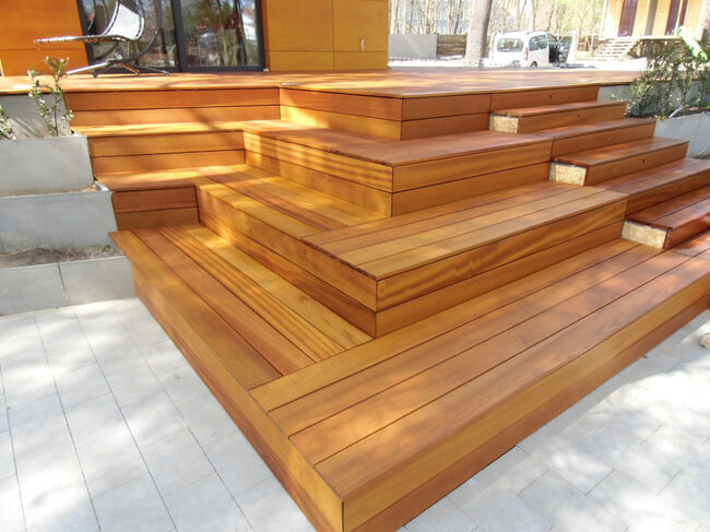 Modern wooden terrace with cascading steps and concrete planters
