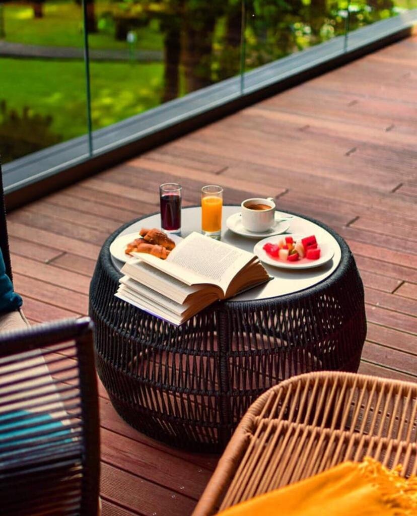 Coffee table and garden furniture on a modern wooden terrace