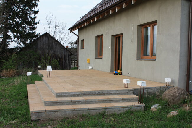 Terrace with light concrete pavers with stairs during finishing