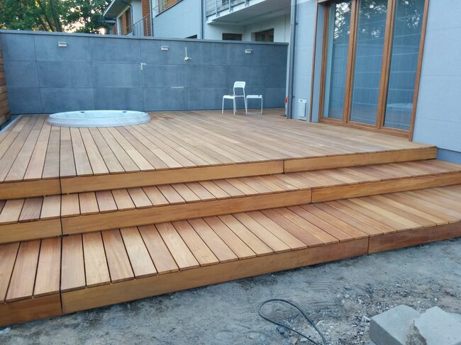 Modern wooden terrace with stairs and built-in garden SPA hot tub