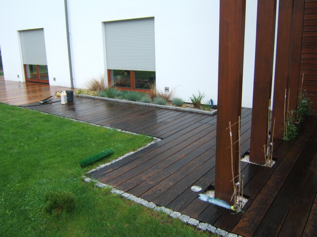 Dark wooden home terrace during cleaning and oiling