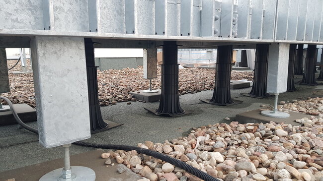 High adjustable pedestals for a steel terrace structure on the roof