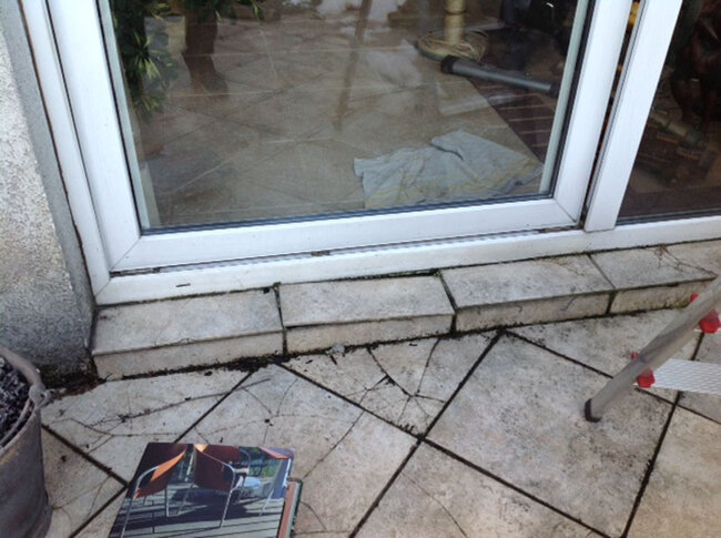 Damaged thresholds and cracked terrace pavers at the terrace door