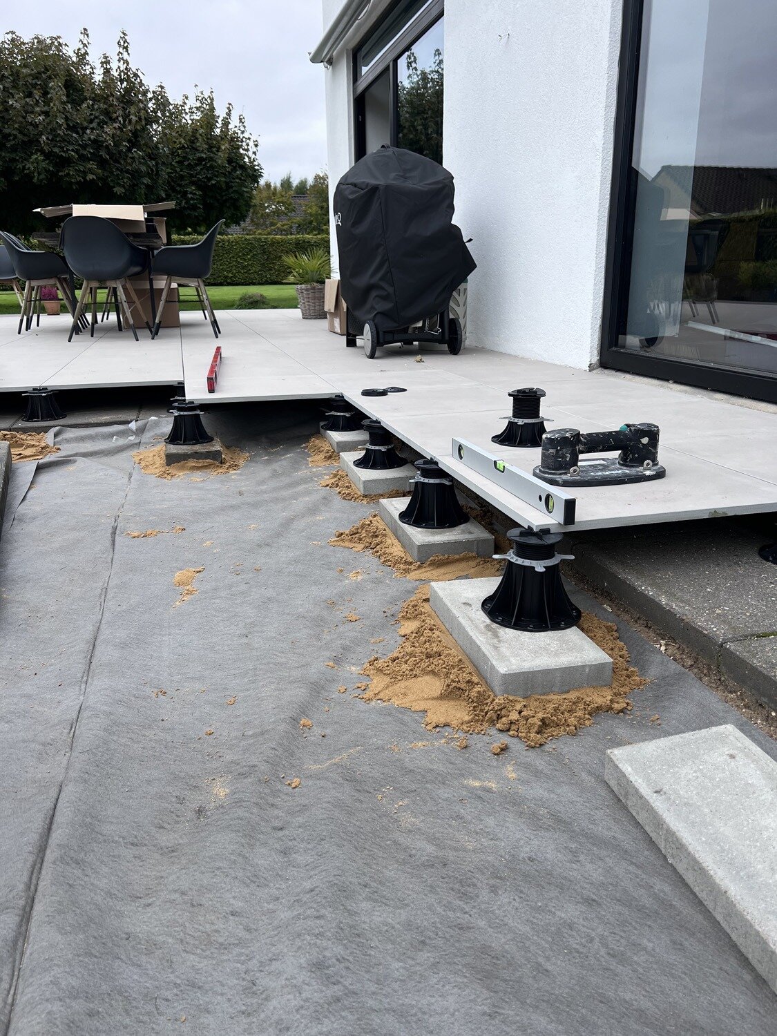 Construction for a raised deck terrace with pedestals and joists