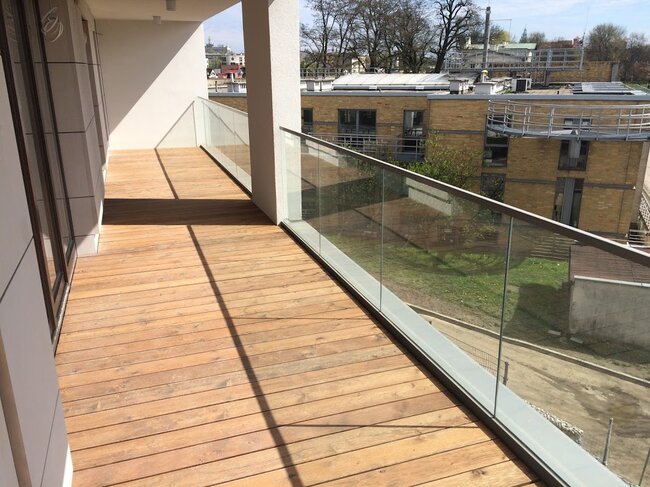 Modern rooftop viewing terrace with a grill zone and glass railings