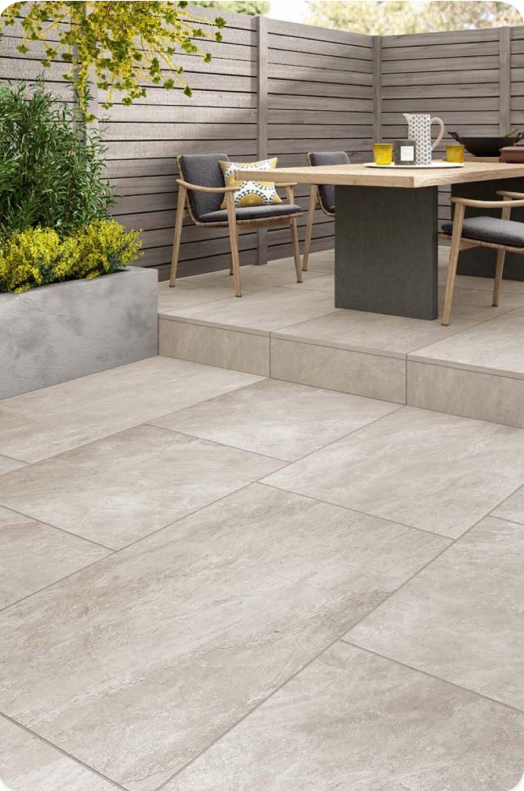 Two-level terrace with light porcelain tiles and garden furniture